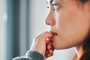 Closeup of woman biting her nails