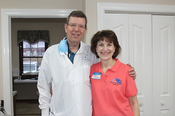 Dentist and team member smiling together