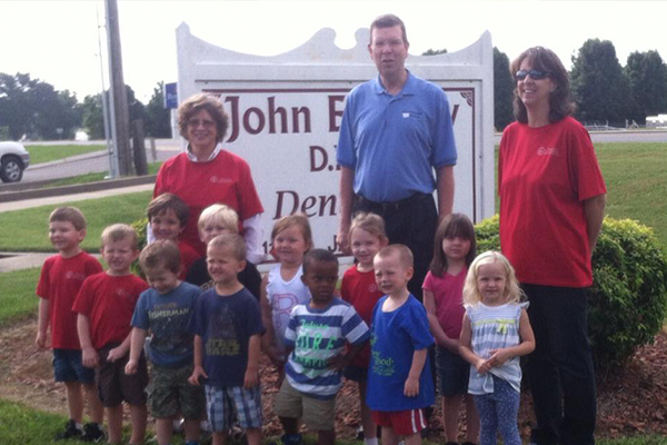 Dentist team members and kids at community event