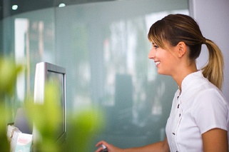 Smiling dental team member exploring payment options for patient