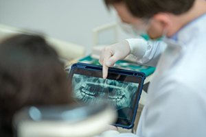 Dentist and patient looking at X-ray together
