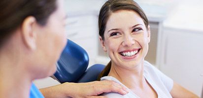 smiling owman in dental chair