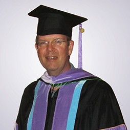 Dr. Petty wearing doctoral robes