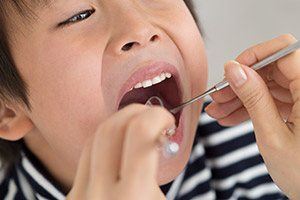 child receiving dental exam
