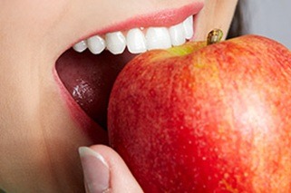Closeup of patient eating an apple
