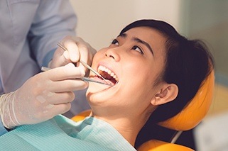 Woman in dental chair receiving treatment