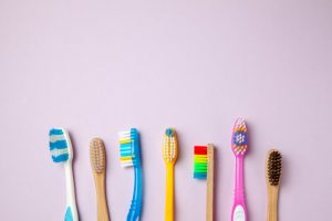 Several different colored toothbrushes on a table