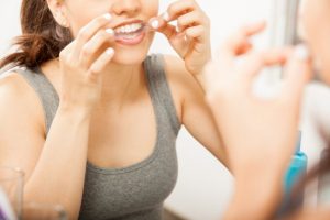 a woman using DIY whitening in Tullahoma to brighten her teeth 