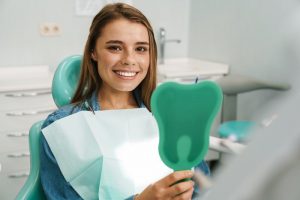 young woman smiling in dental chair