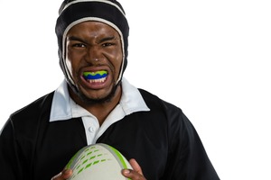 Male athlete wearing mouthguard and holding ball